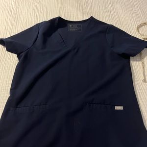 Figs navy blue scrub set, medium. One small stain on the leg (see pic).